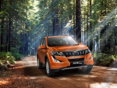 2015-mahindra-xuv5oo-facelift-pics-front-angle-sunset-orange