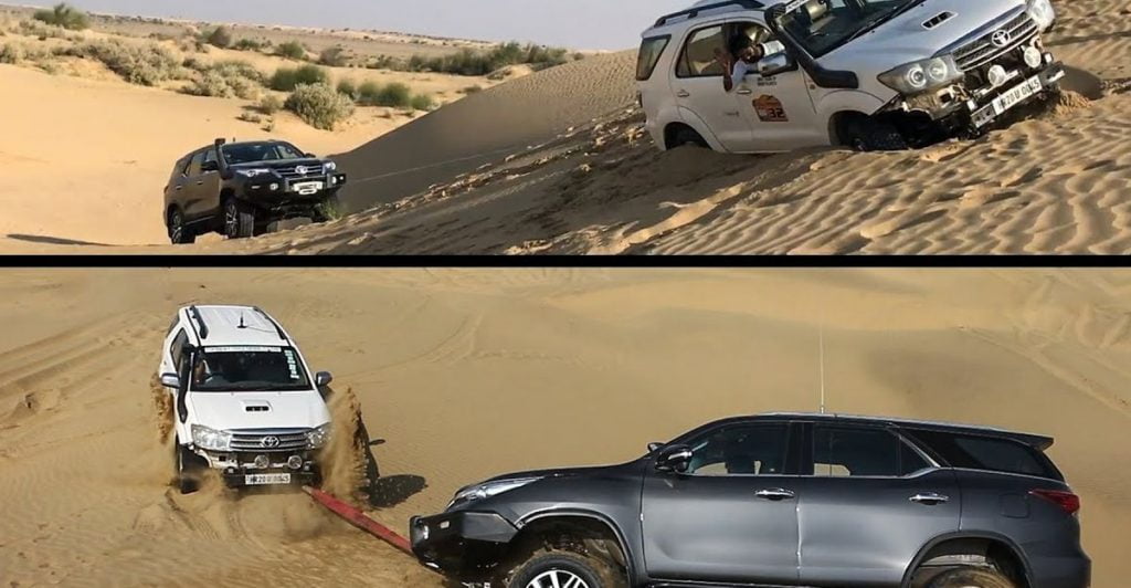 Watch a new and old Toyota Fortuner winch each other out of heavy sand. 