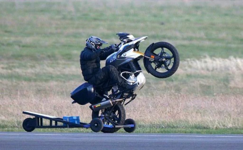 Tom Cruise seen popping wheelies on a BMW G 310 G on the sets of the new Mission Impossible film. 