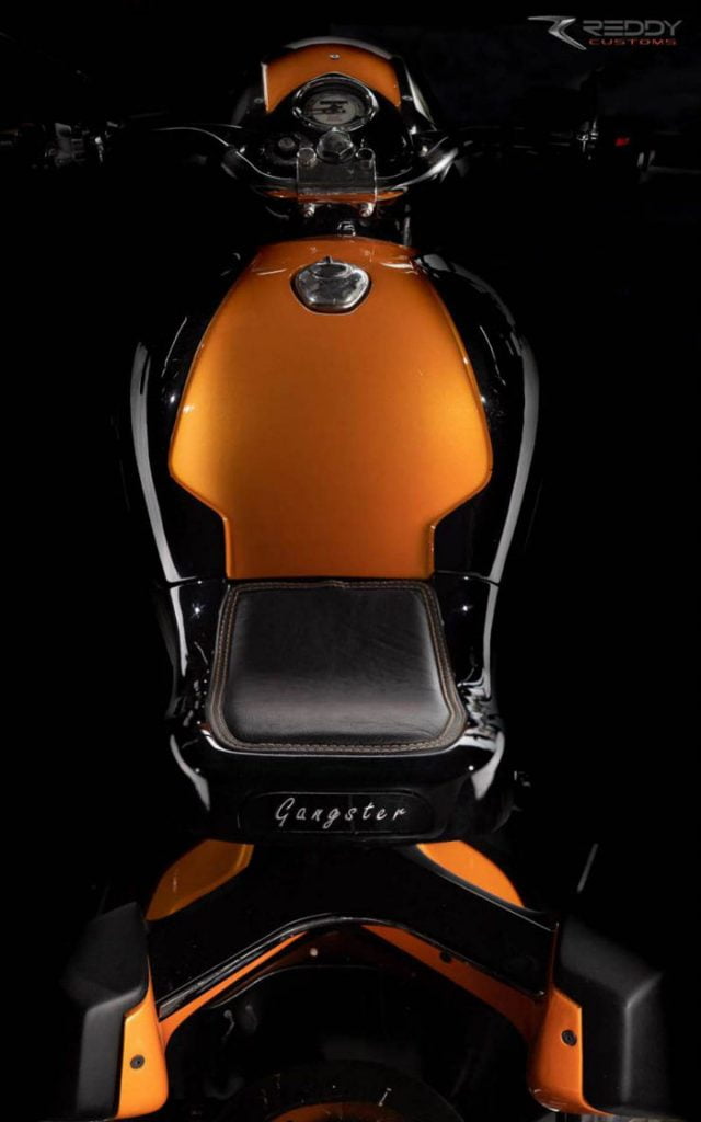 When you view the motorcycle from top, it appears to be painted in a dual-tone shade of black and orange with silver accents.