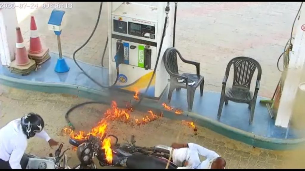 Motorcycle engulfed in flames as petrol pump staff is caught using phone. 