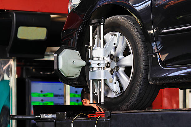 Car wheel fixed with computerized wheel alignment machine clamp.