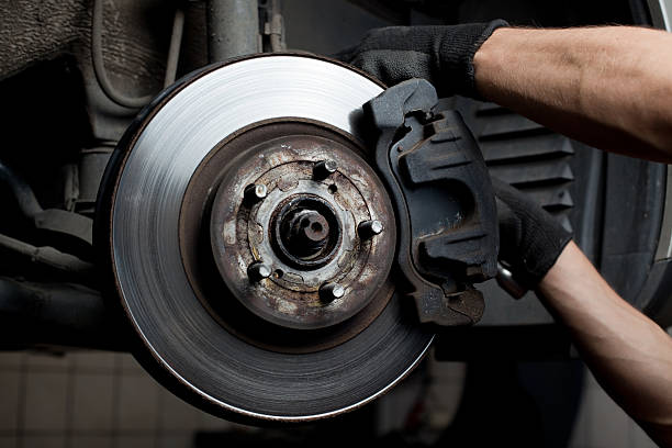 Closeup of Car Mechanic Repairing Brake Pads Car Blog India Replace Brake Pads Car