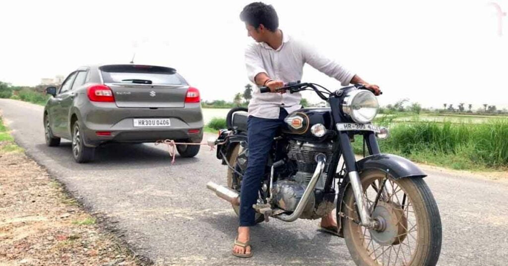 Royal Enfield Bullet 350 towing a Maruti Baleno 