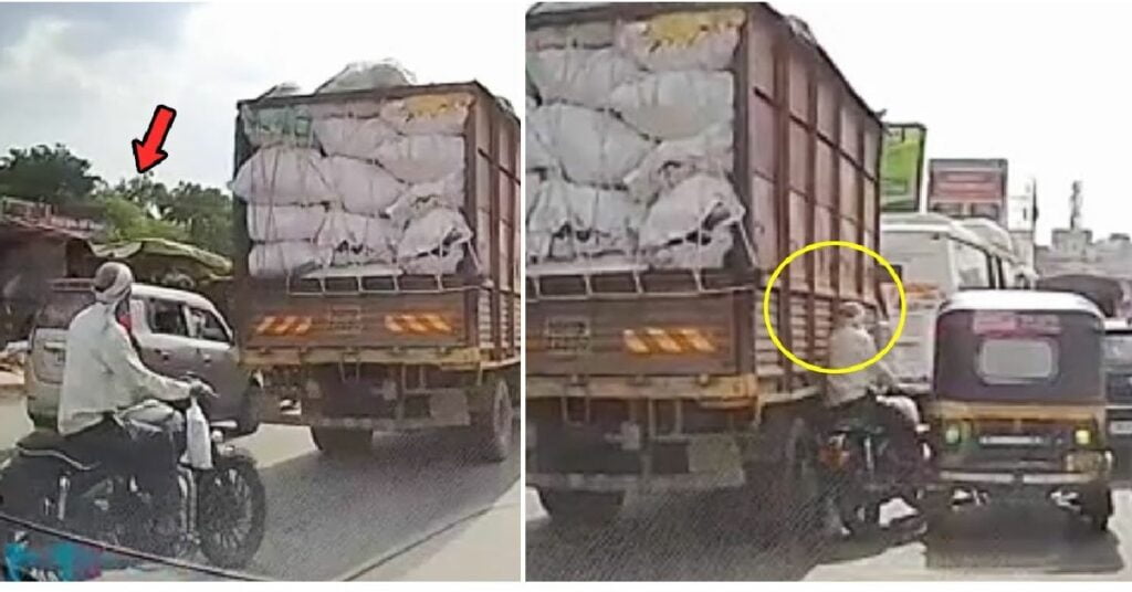 Biker Gets Stuck Between Truck and Auto