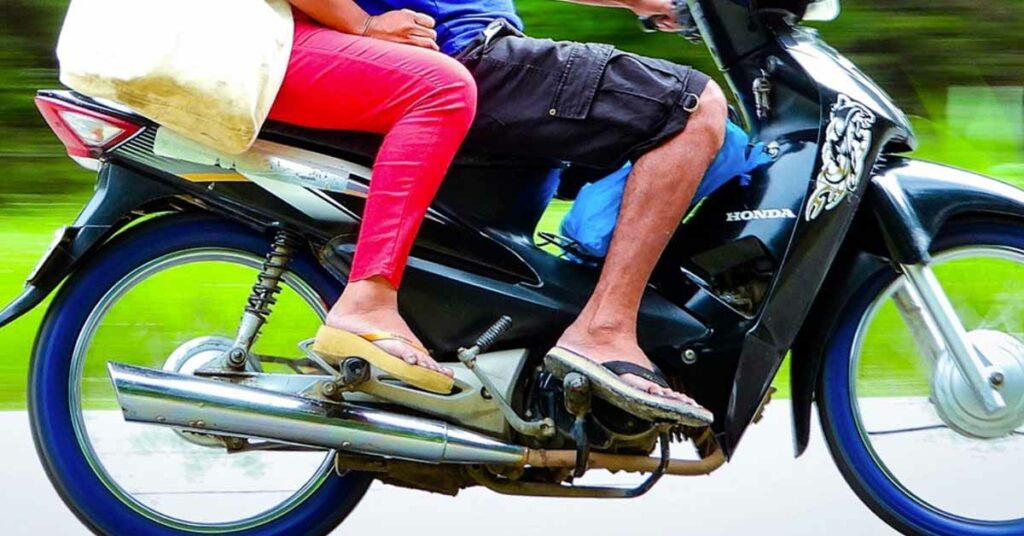 wearing slippers riding two-wheeler