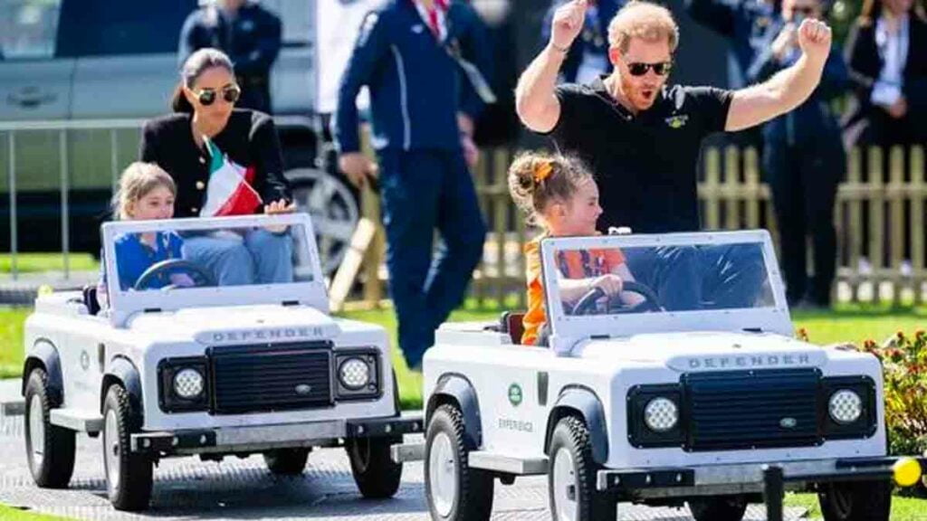 Prince Harry and Meghan Markle driving mini Land Rover Defenders