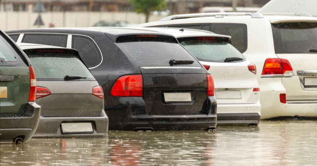 cars submerged in water in parking areas in UAE