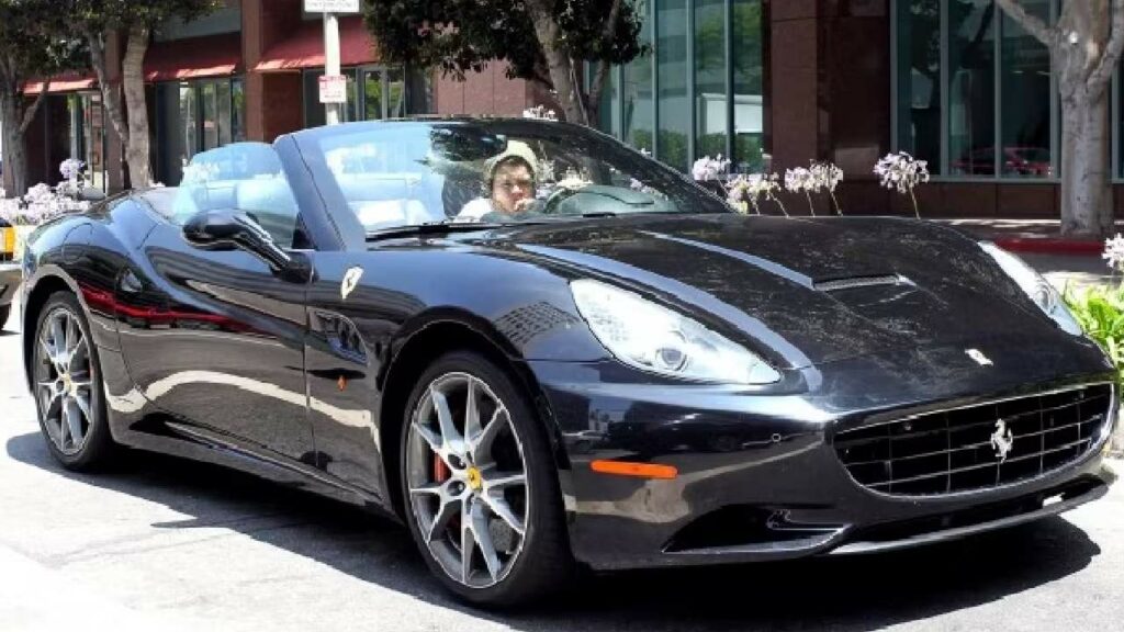 Harry Styles with his Ferrari California