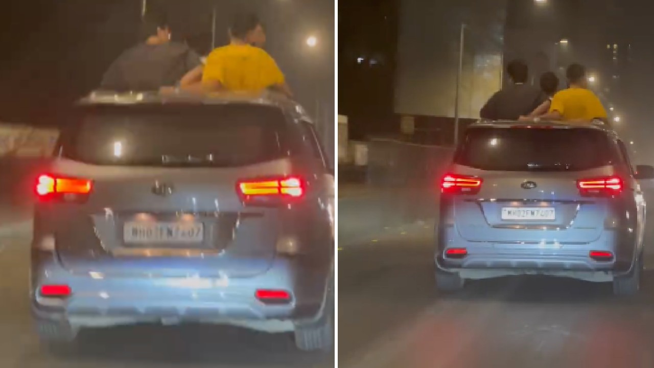 4 People Stand Out of Sunroof of Kia Carnival