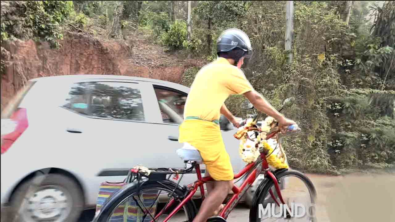 Aged Villager Riding Bicycle with Helmet and Taillamp
