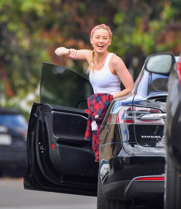 Amber Heard with Her Tesla Model S