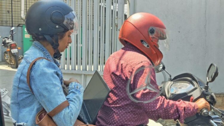 Bangalore Woman Working on Laptop in Traffic