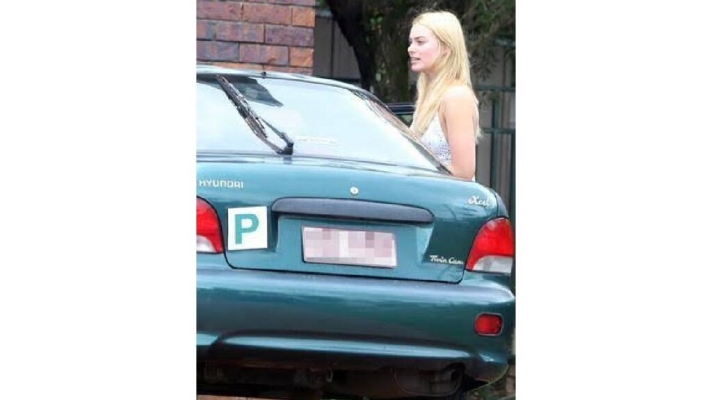 Margot Robbie with her Hyundai Excel