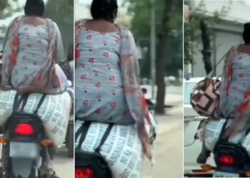 Pillion Sits on Sack of Flour on Bike on Road