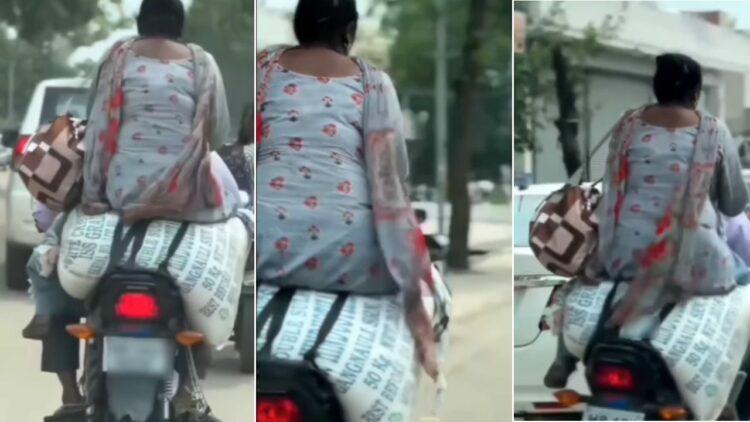 Pillion Sits on Sack of Flour on Bike on Road