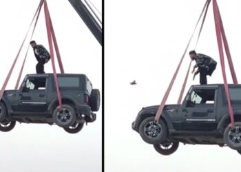 Man Stands on Roof of Mahindra Thar