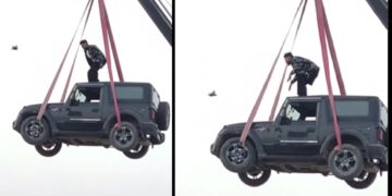 Man Stands on Roof of Mahindra Thar