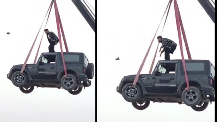 Man Stands on Roof of Mahindra Thar