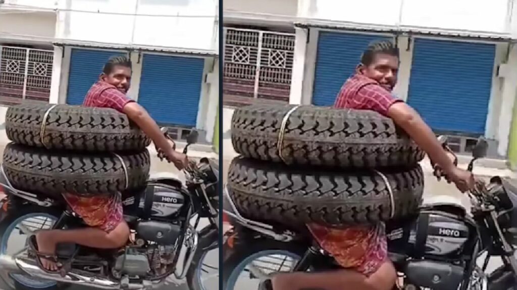 Man with Tyre Around his Body on a Bike