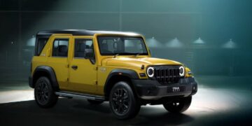 mahindra thar roxx star edition yellow black paint theme front three quarters