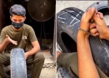 Roadside Worker Carving Grooves on a Worn-Out Tyre to Make it New